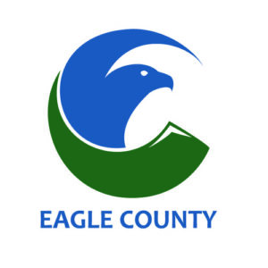 Stylized eagle within a circular shape, featuring a blue upper half and a green lower half resembling a mountain. Text below reads "Eagle County.